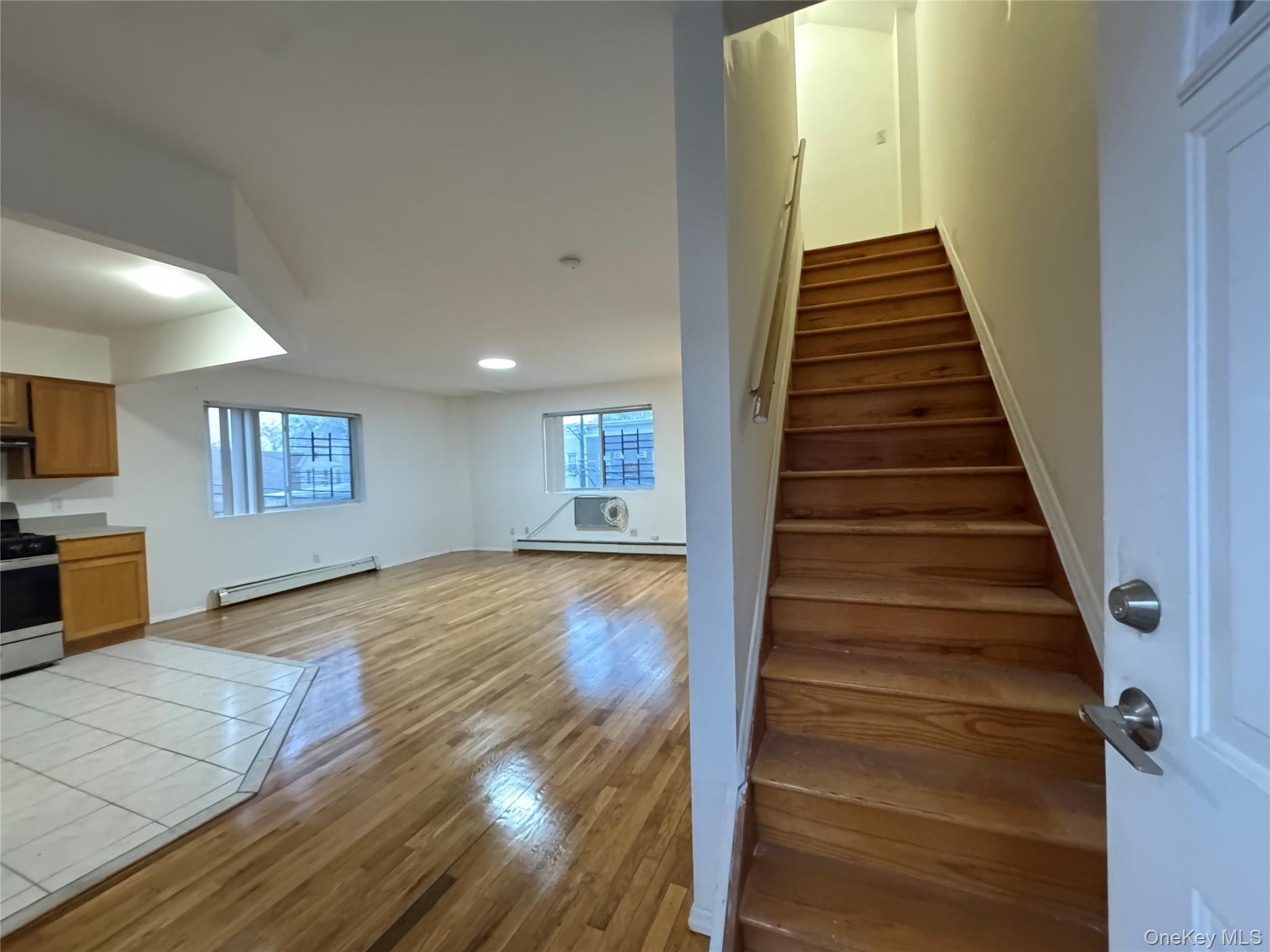 103-25 Alstyne Avenue Queens, NY 11368 - Photo 3 of 22 a view of a hallway view with wooden floor and staircase