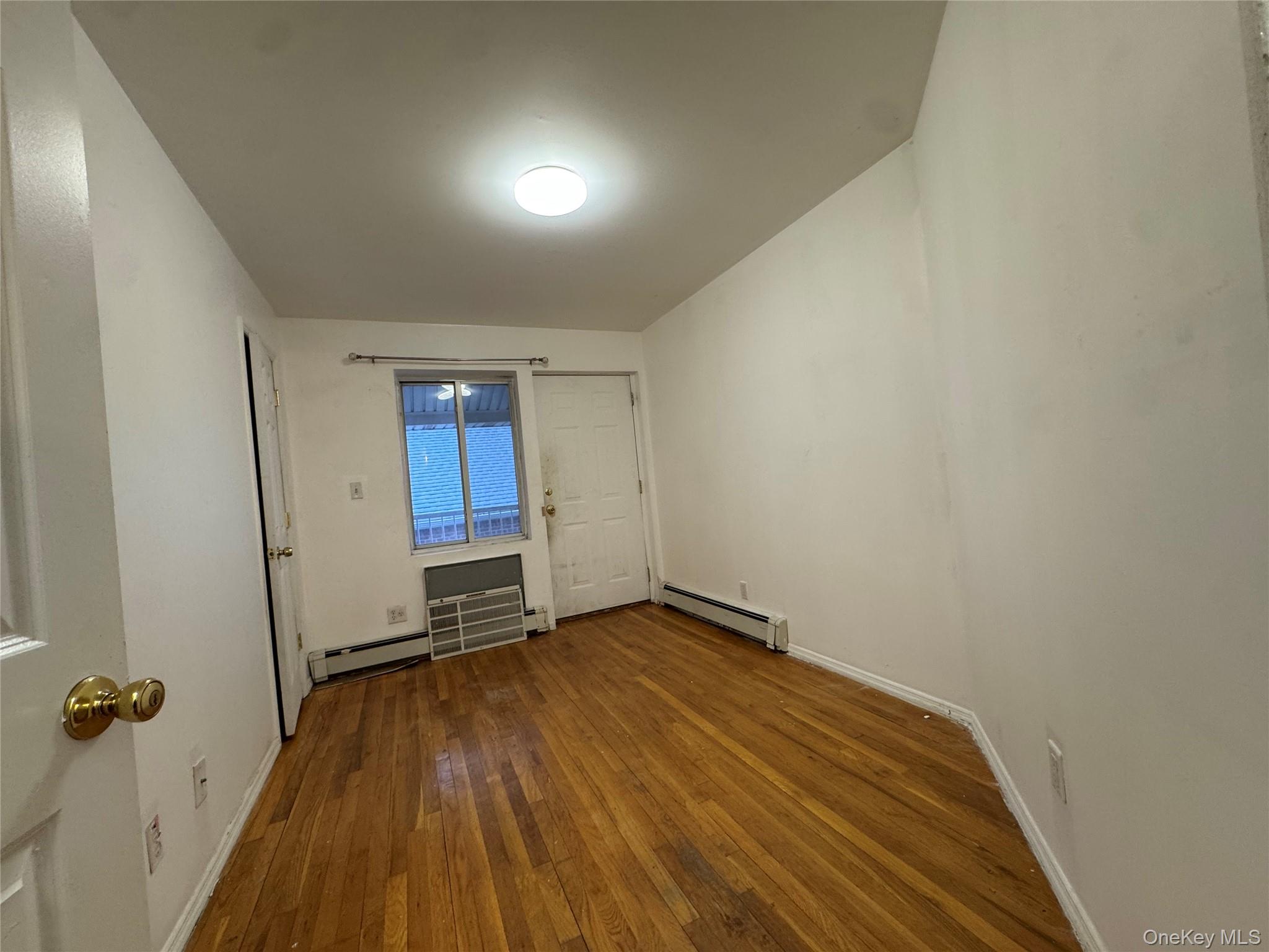 103-25 Alstyne Avenue Queens, NY 11368 - Photo 4 of 22 an empty room with wooden floor and closet