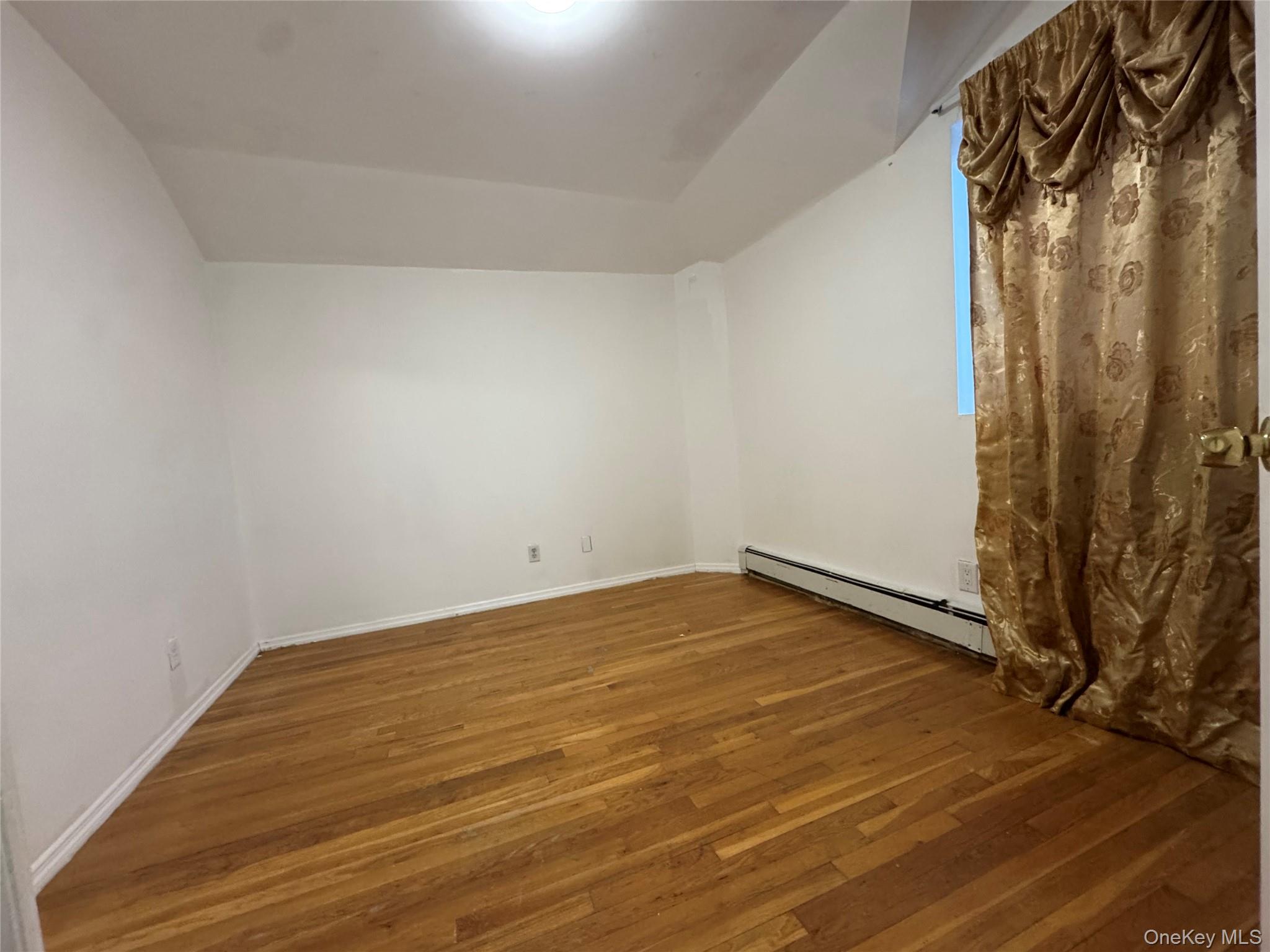 103-25 Alstyne Avenue Queens, NY 11368 - Photo 6 of 22 a view of a room with wooden floor and shower