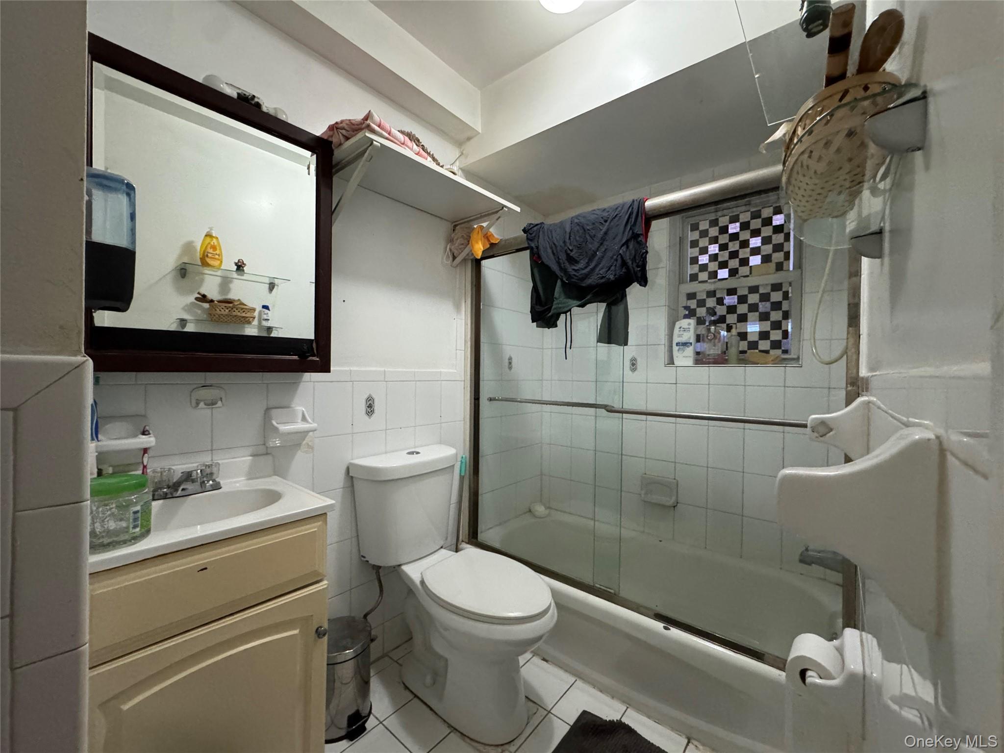 103-25 Alstyne Avenue Queens, NY 11368 - Photo 9 of 22 a bathroom with a sink a toilet and shower