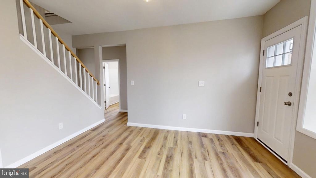 10 Linden Street Bridgeton, NJ 08302 - Photo 27 of 89 a view of an empty room with wooden floor and stairs