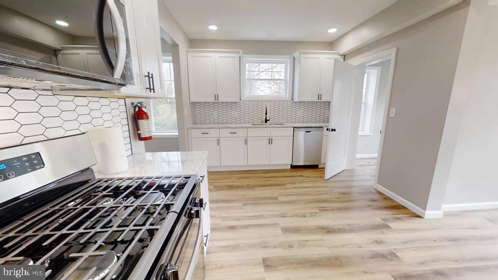 10 Linden Street Bridgeton, NJ 08302 - Photo 46 of 89 a kitchen with granite countertop a stove and a sink