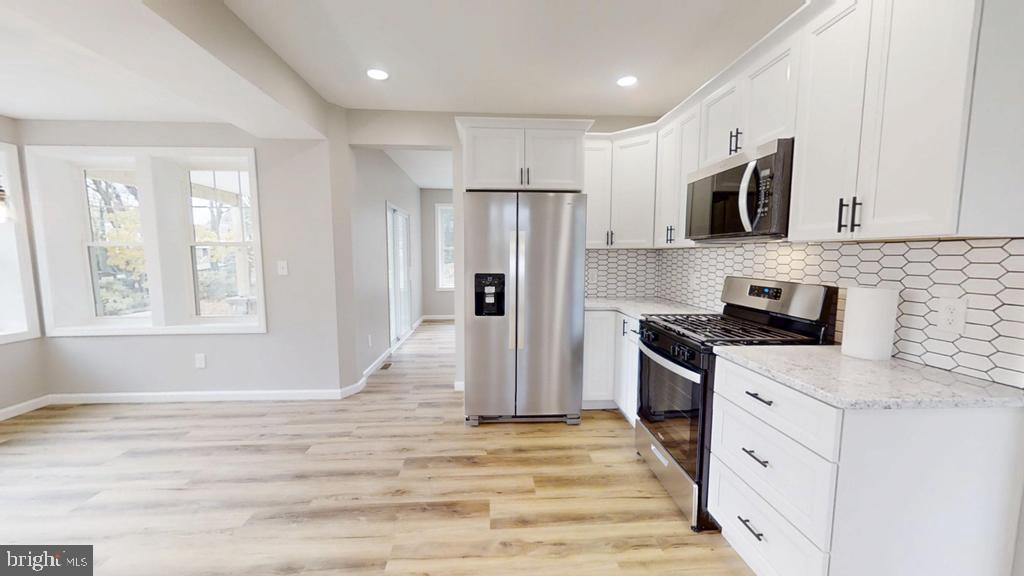 10 Linden Street Bridgeton, NJ 08302 - Photo 47 of 89 a kitchen with stainless steel appliances granite countertop a stove a sink and a refrigerator