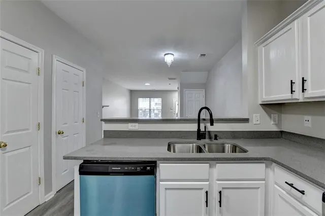 a view of a kitchen with a sink and cabinets