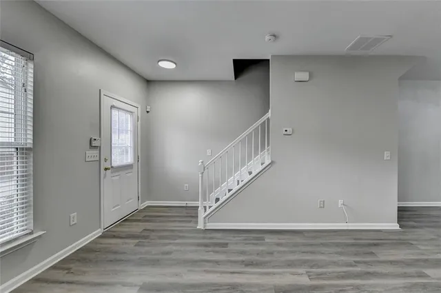 a view of entryway and hall with wooden floor
