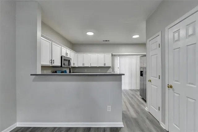 a view of a kitchen with a refrigerator a sink and dishwasher