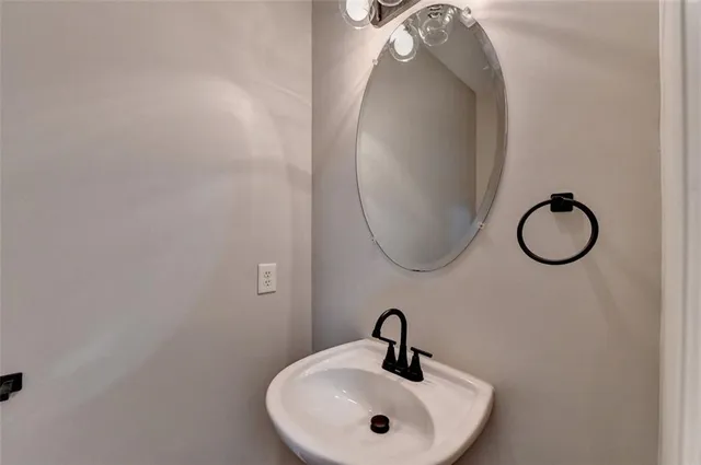 a bathroom with a sink and mirror