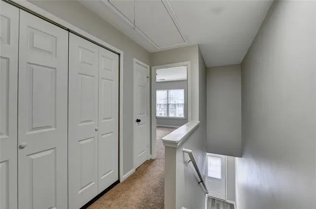 a view of a hallway with wooden floor and entryway