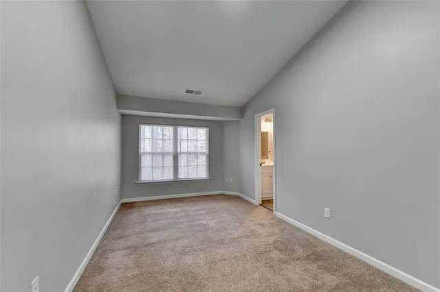 an empty room with a empty space and windows