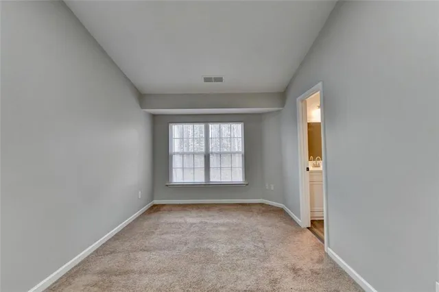 an empty room with a empty space and windows