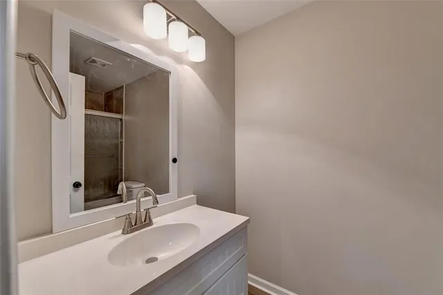 a bathroom with a glass shower door