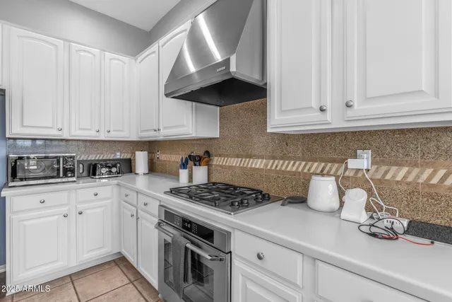 a kitchen with a sink stove and cabinets