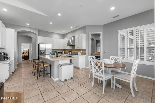 a view of kitchen with windows and chairs