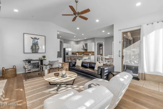 a living room with furniture a table and a large window