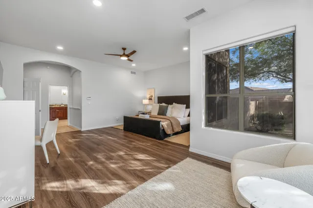 a bedroom with furniture and a flat screen tv