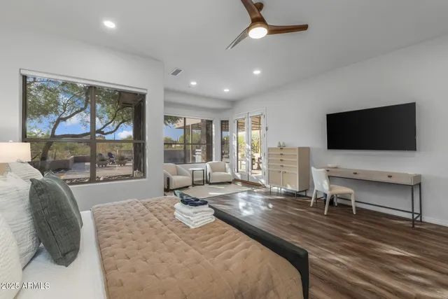 a large spacious bathroom with a granite countertop tub a double vanity sink and a large mirror