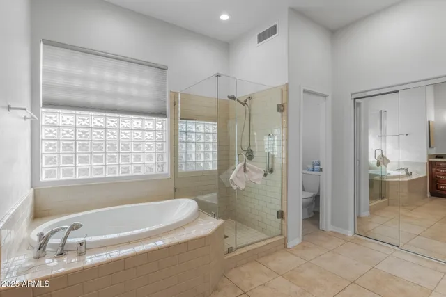 a large bathroom with a large tub and sink