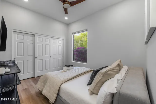 a bathroom with a granite countertop sink a toilet and a mirror