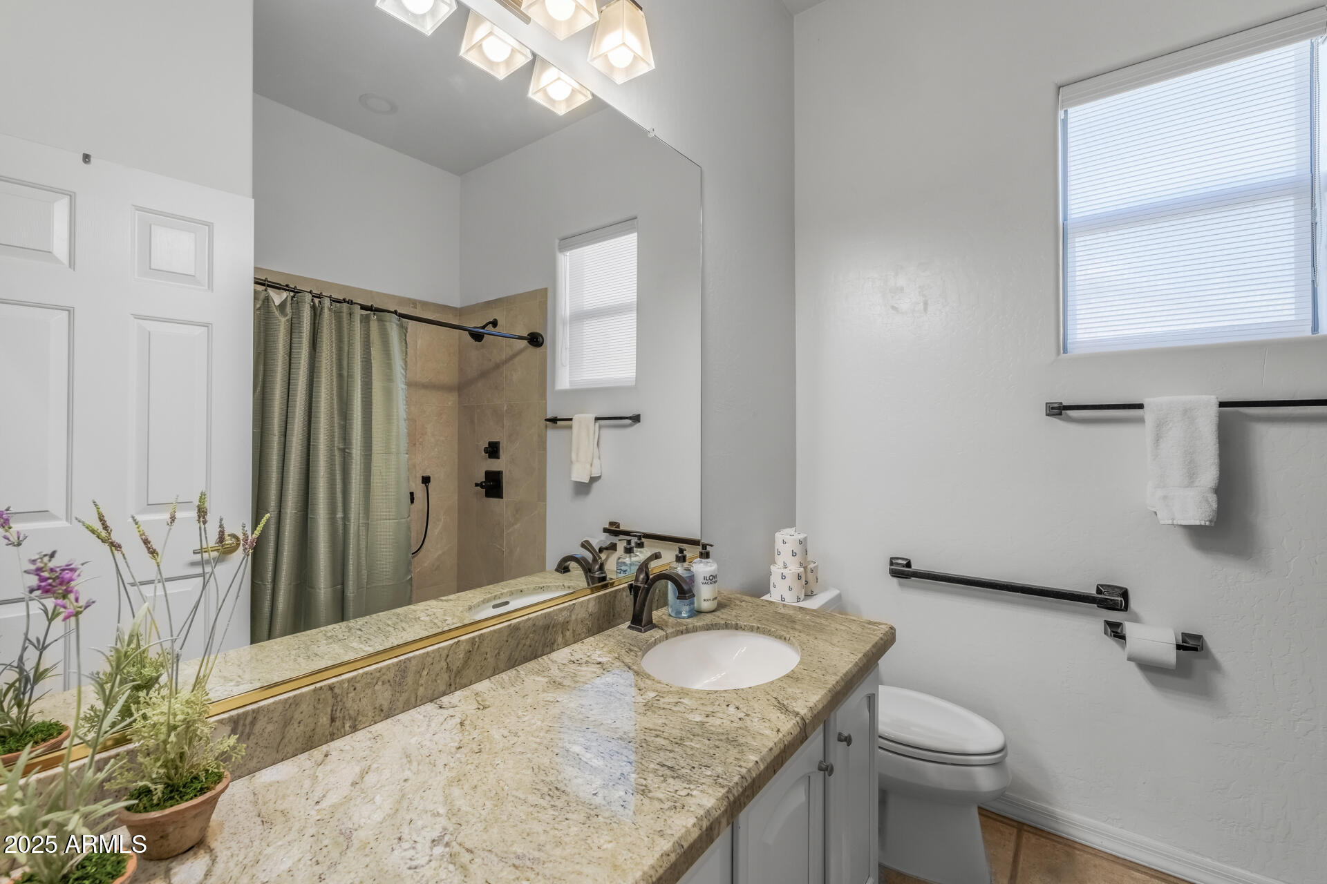 7474 East Red Bird Road Scottsdale, AZ 85266 - Photo 29 of 40 a bathroom with a granite countertop sink a toilet and a mirror