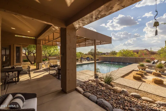 a view of a patio with a table and chairs