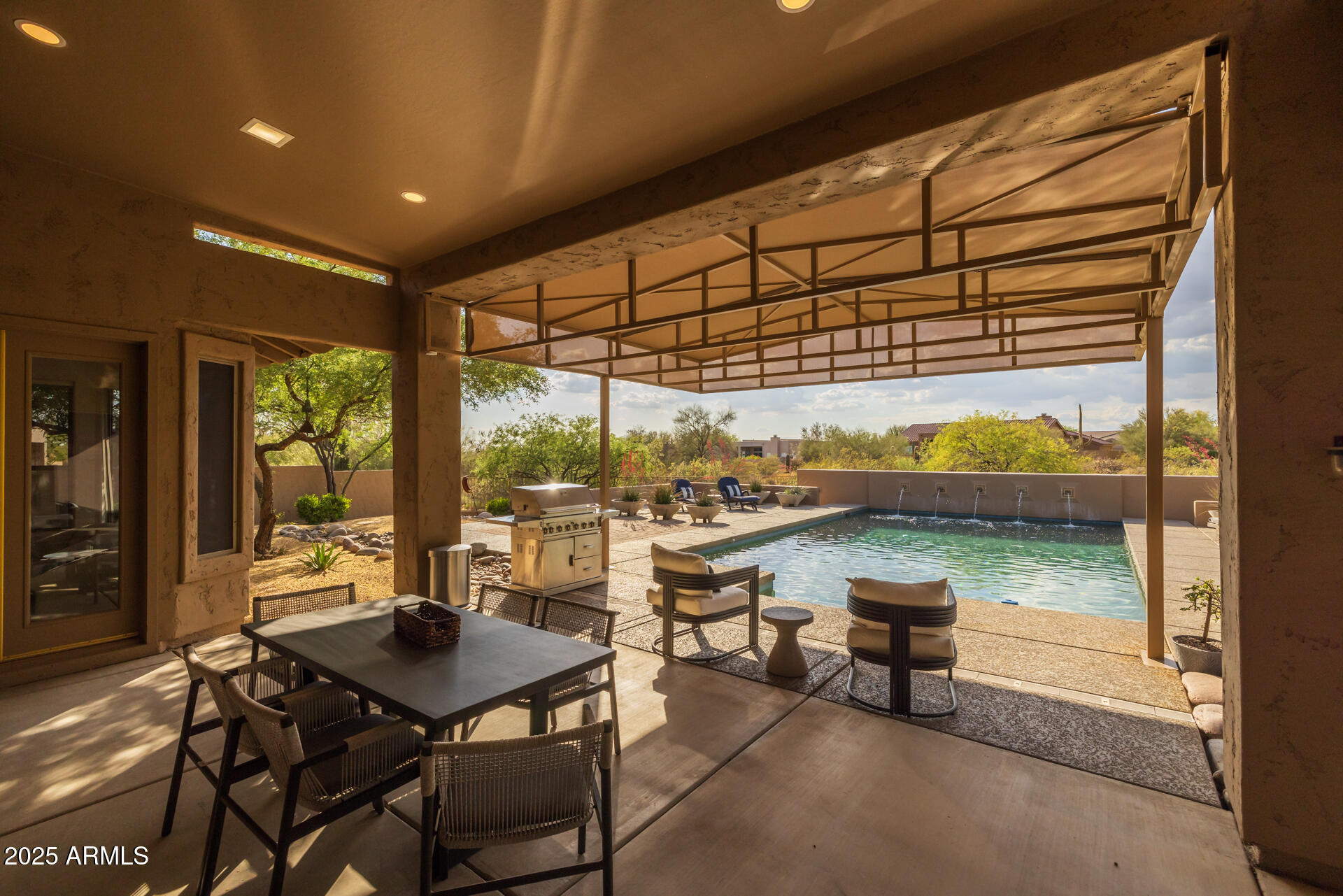 7474 East Red Bird Road Scottsdale, AZ 85266 - Photo 33 of 40 a view of a patio with a table and chairs