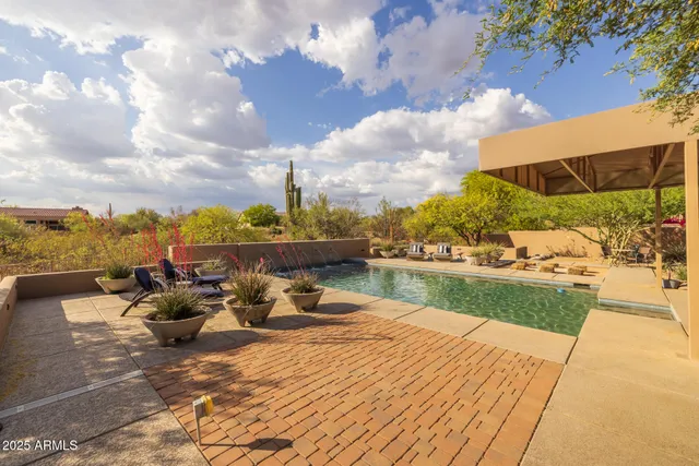 a swimming pool with outdoor seating and yard