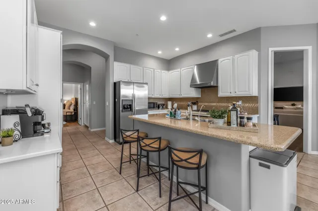 a kitchen with white cabinets and a stove