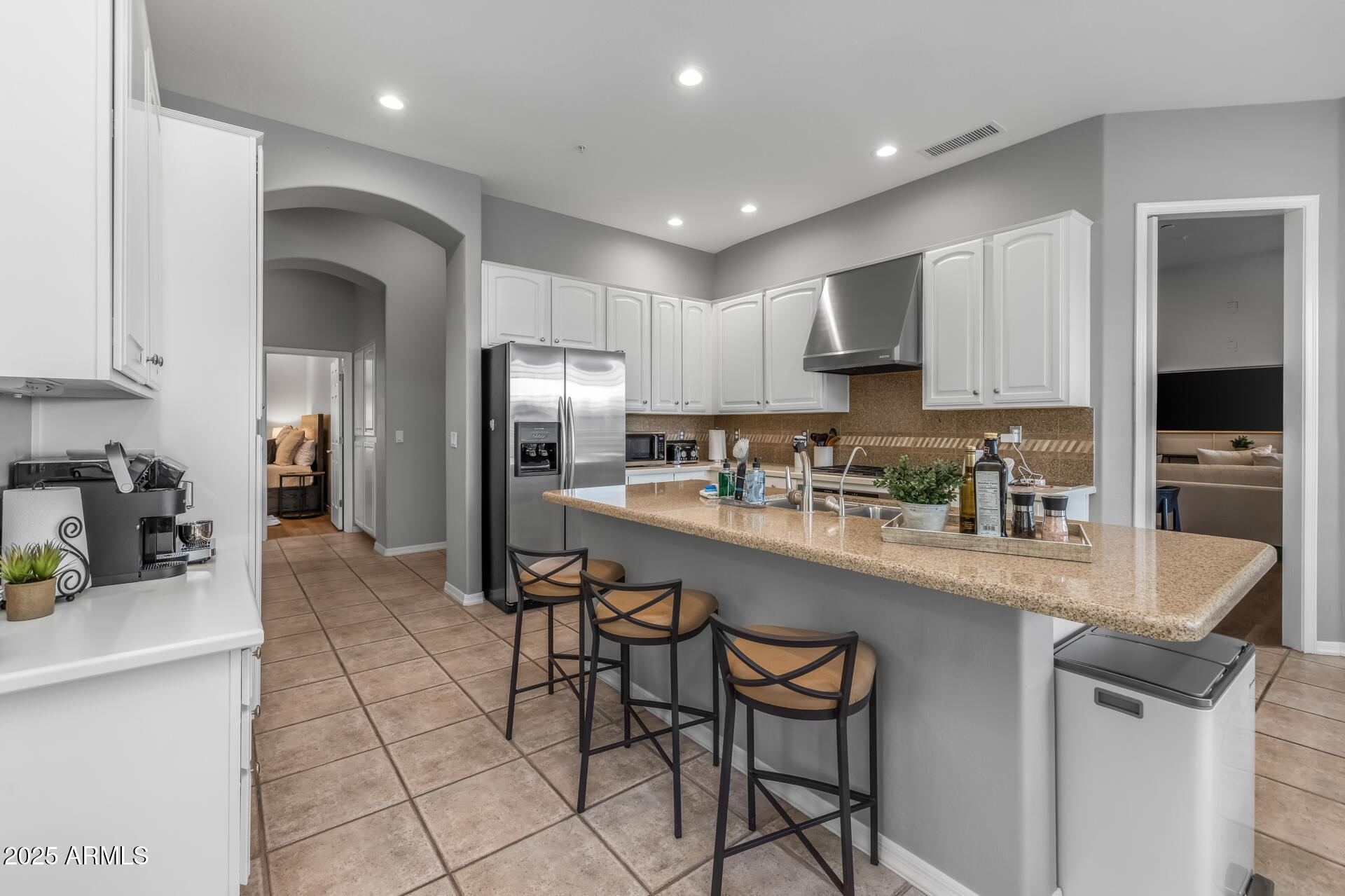 7474 East Red Bird Road Scottsdale, AZ 85266 - Photo 10 of 40 a kitchen with stainless steel appliances granite countertop a refrigerator and a stove top oven