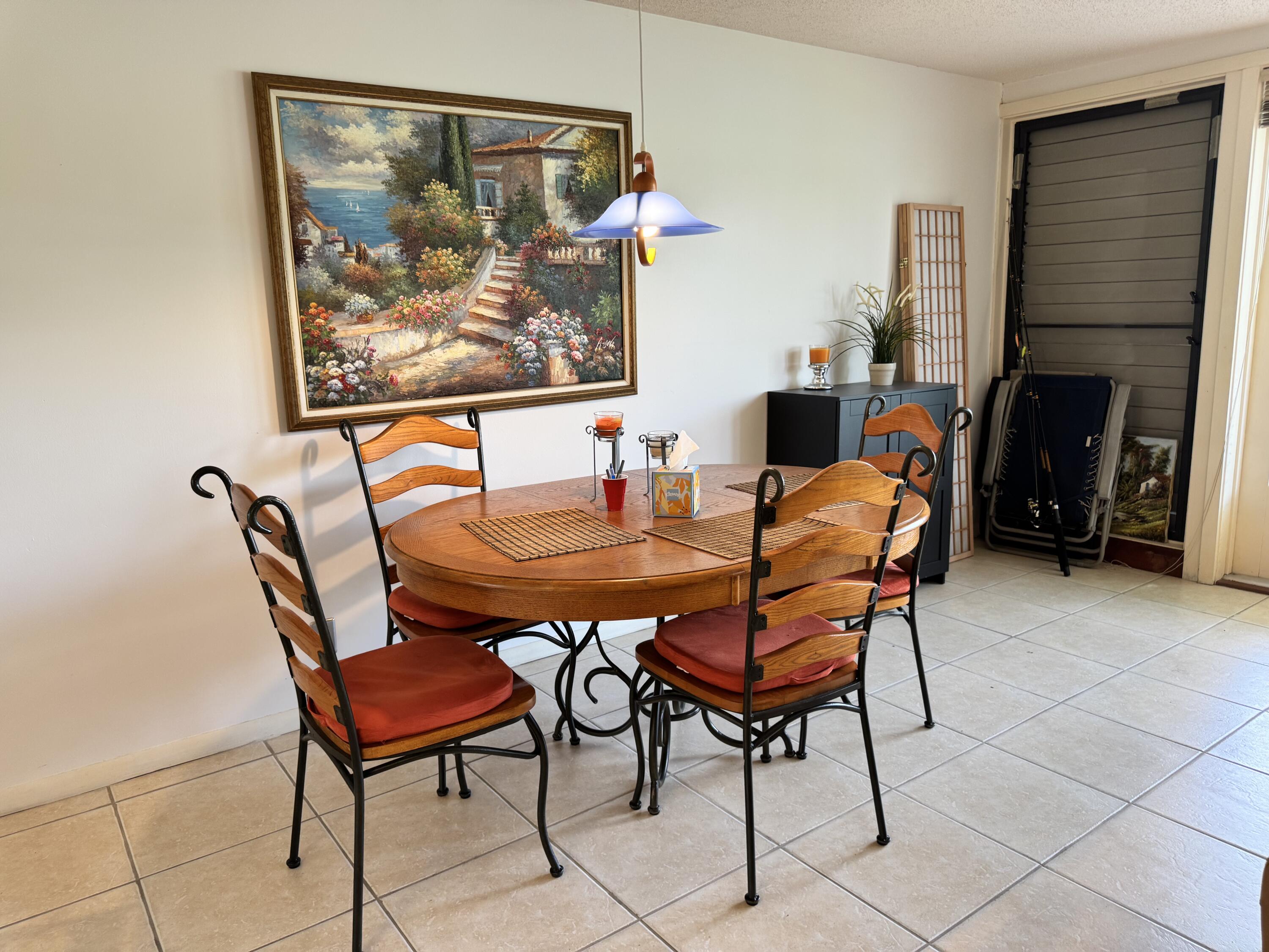 20061 Boca W Drive Boca Raton, FL 33434 - Photo 2 of 8 a dining room with furniture and a fireplace