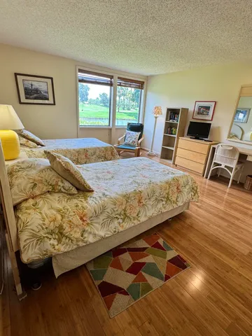 a view of a two chairs in the park next to a yard