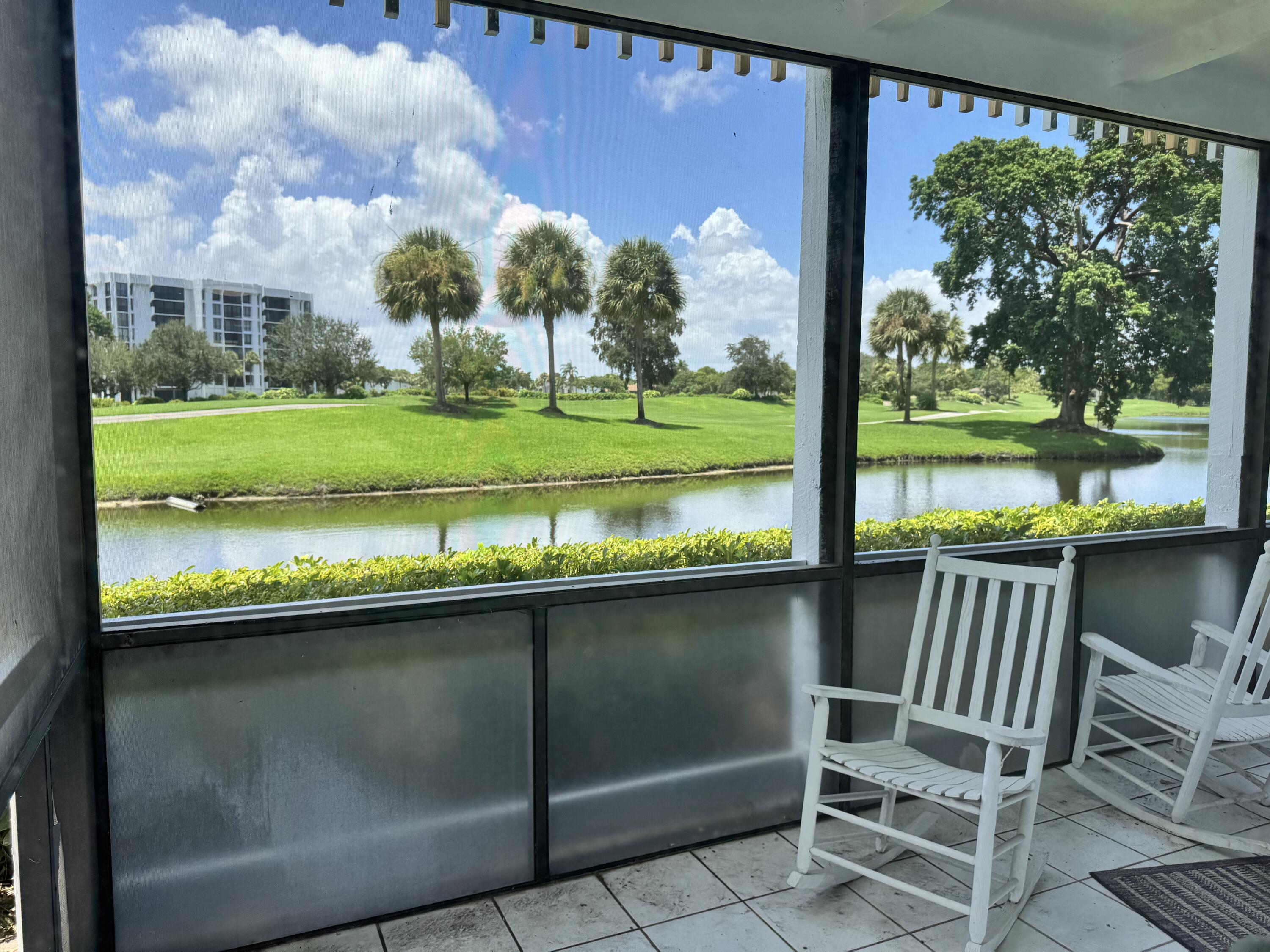 20061 Boca W Drive Boca Raton, FL 33434 - Photo 7 of 8 a view of a two chairs in the park next to a yard