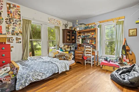 a bedroom with bed and a large window