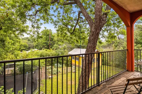 a view of a balcony with wooden fence and floor