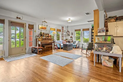 a living room with furniture and wooden floor