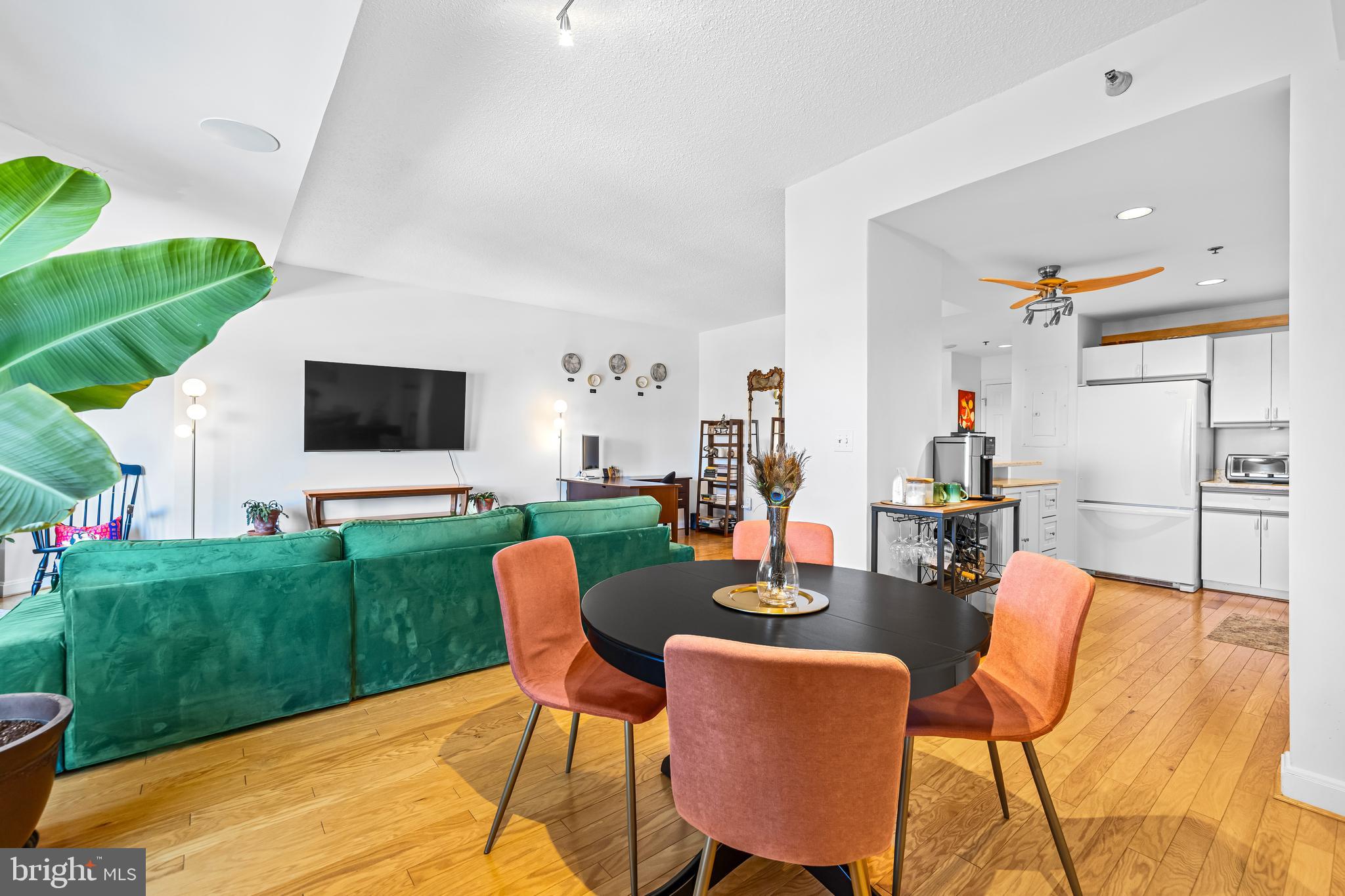 2515 Boston Street, Unit 1206 Baltimore, MD 21224 - Photo 11 of 29 a dining room with furniture and a garden