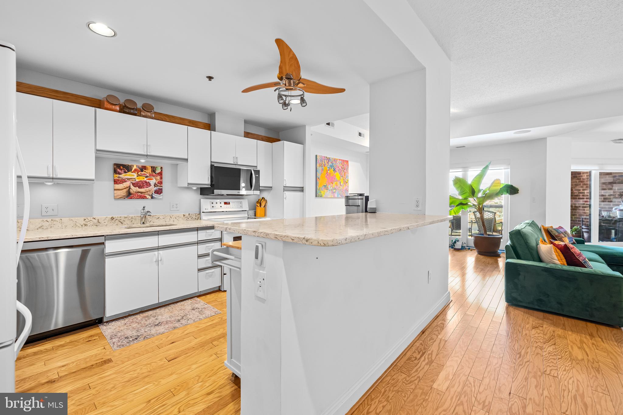 2515 Boston Street, Unit 1206 Baltimore, MD 21224 - Photo 13 of 29 a kitchen with stainless steel appliances granite countertop a sink dishwasher stove and refrigerator