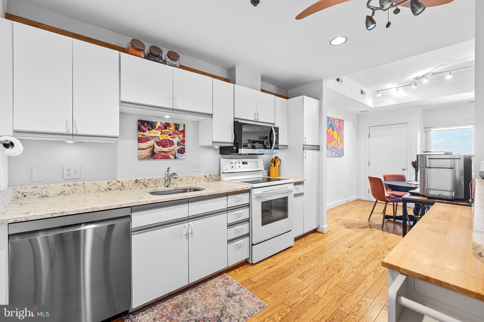 2515 Boston Street, Unit 1206 Baltimore, MD 21224 - Photo 14 of 29 a kitchen with granite countertop a sink appliances cabinets and furniture