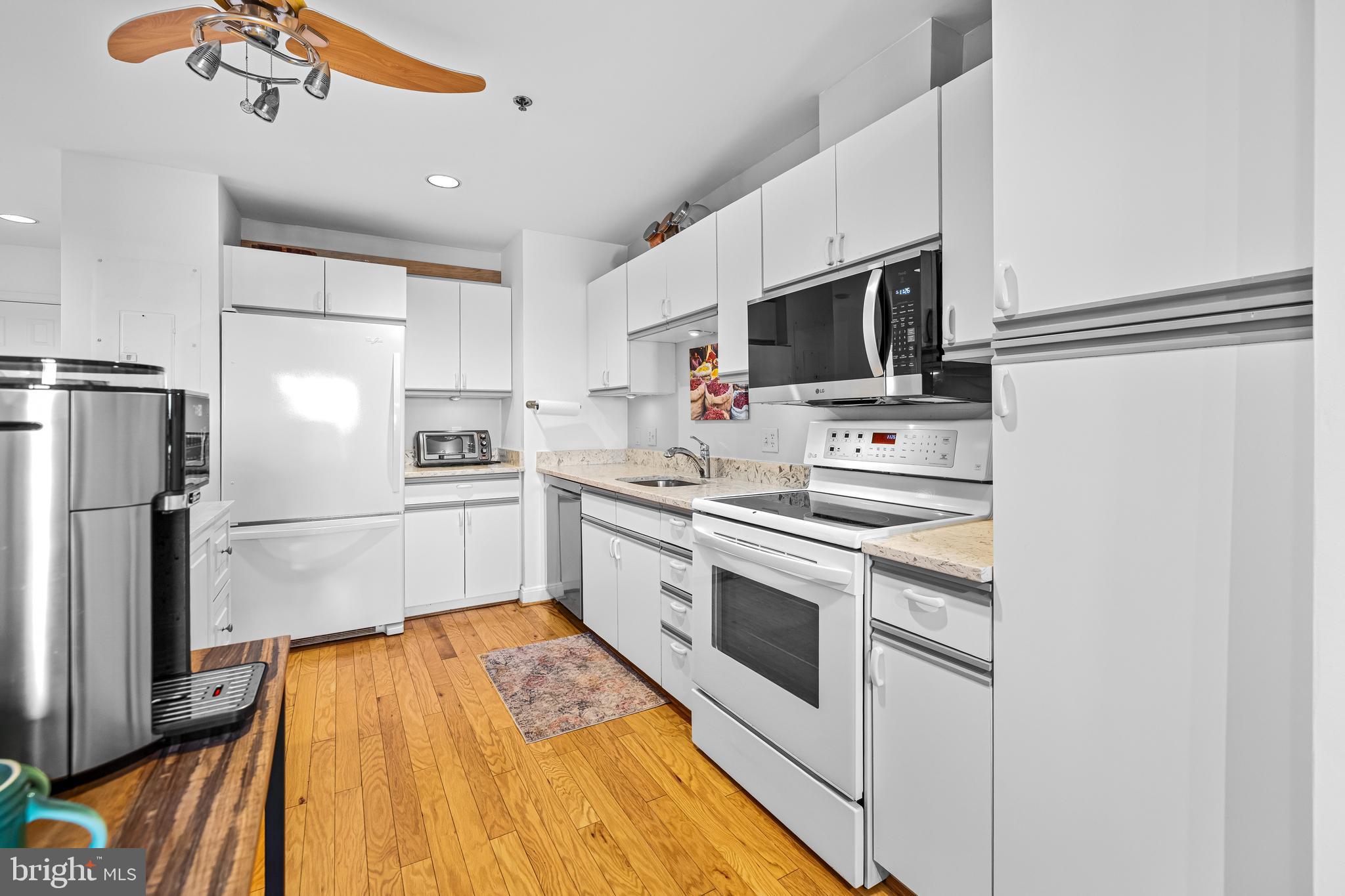 2515 Boston Street, Unit 1206 Baltimore, MD 21224 - Photo 15 of 29 a kitchen with stainless steel appliances a refrigerator sink and microwave