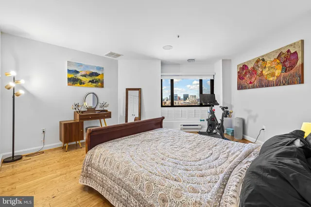 a bedroom with a bed and a dresser in it