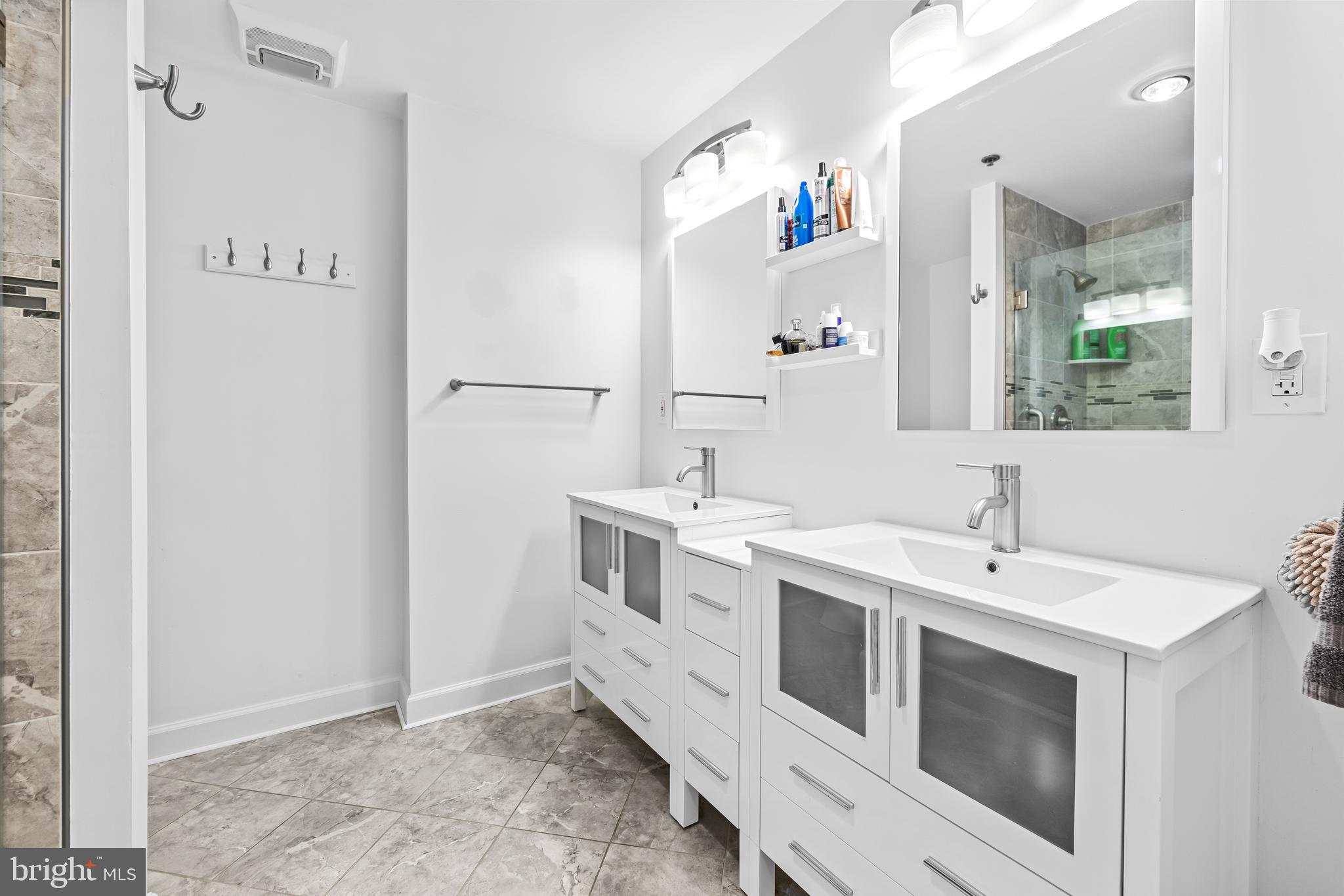 2515 Boston Street, Unit 1206 Baltimore, MD 21224 - Photo 20 of 29 a bathroom with a sink and a mirror