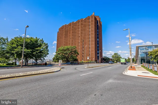 a view of a tall buildings with a cars parked in front of it