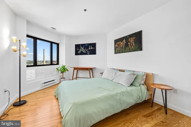 a spacious bedroom with a bed and a desk