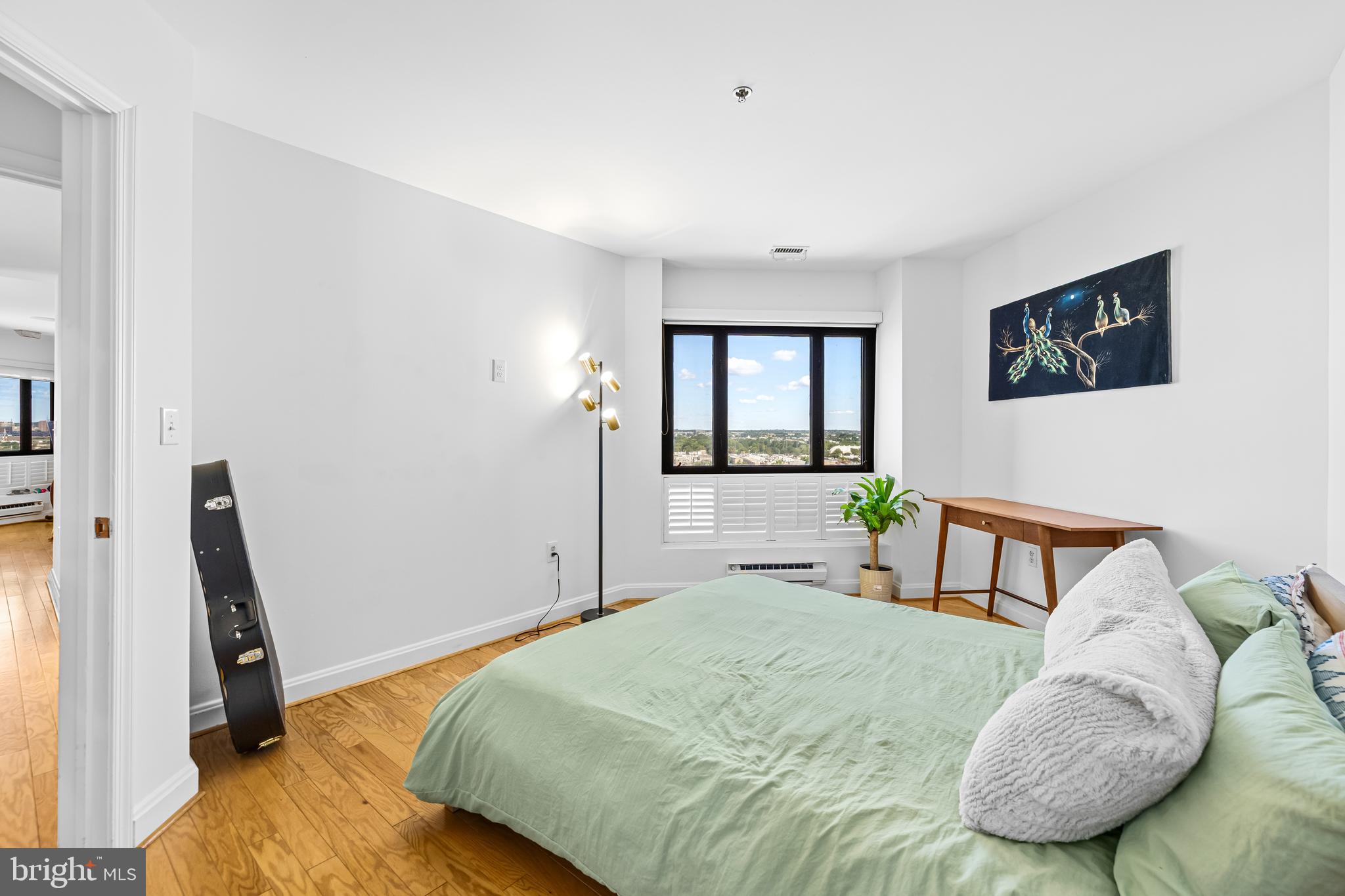 2515 Boston Street, Unit 1206 Baltimore, MD 21224 - Photo 23 of 29 a bedroom with a bed a couch and a window