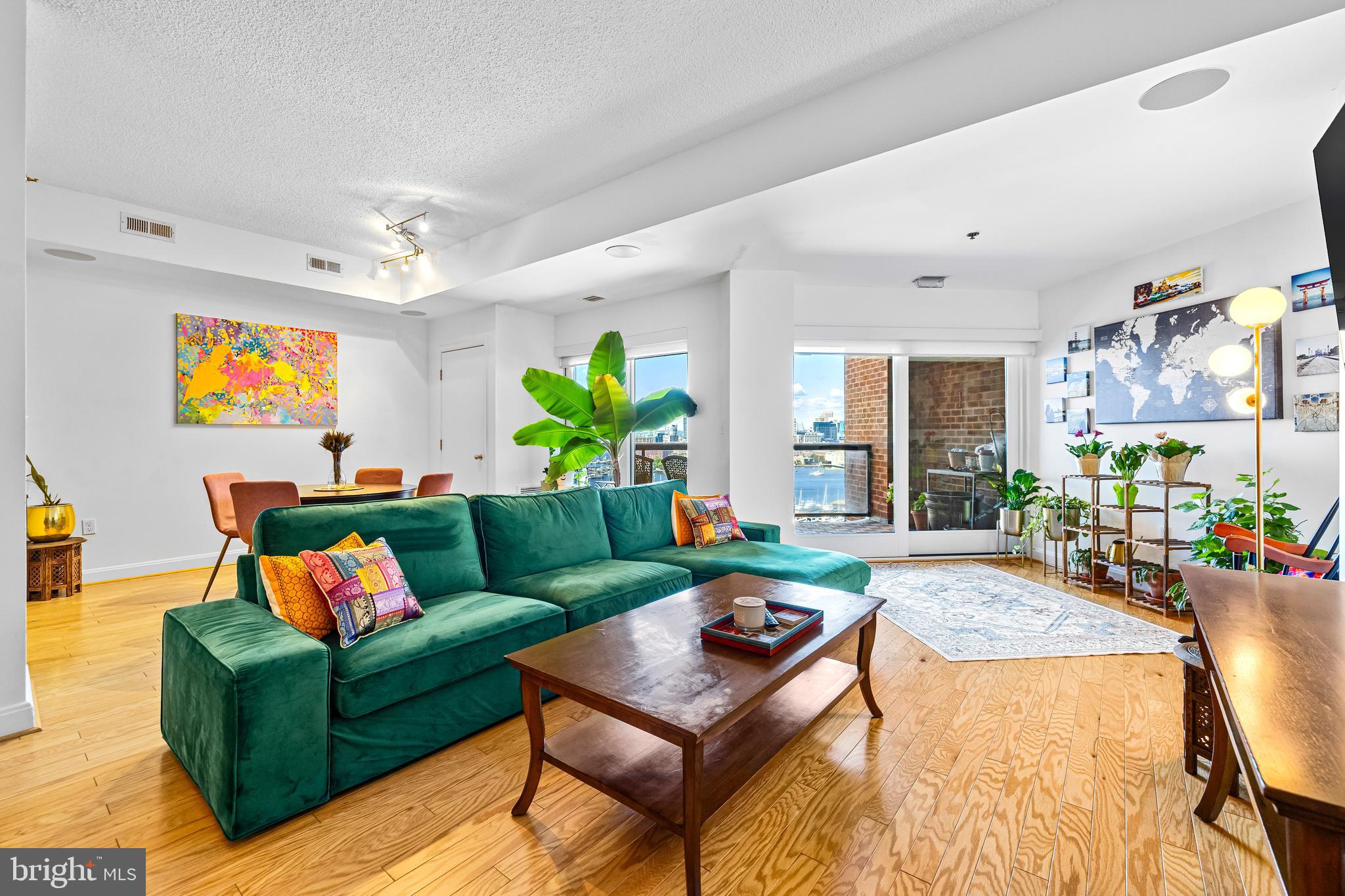 2515 Boston Street, Unit 1206 Baltimore, MD 21224 - Photo 7 of 29 a living room with furniture and a flat screen tv