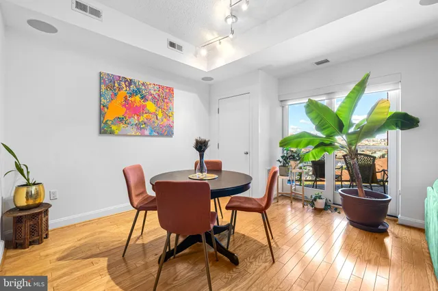 a view of a dining room with furniture window and wooden floor