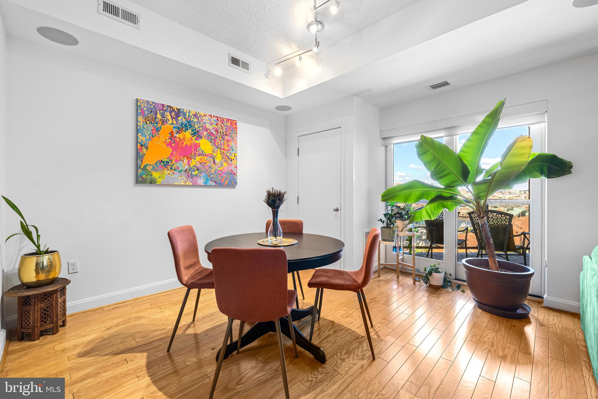 2515 Boston Street, Unit 1206 Baltimore, MD 21224 - Photo 10 of 29 a view of a dining room with furniture window and wooden floor