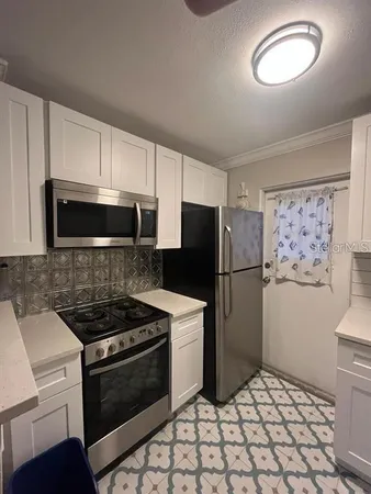 a kitchen with a refrigerator stove and microwave