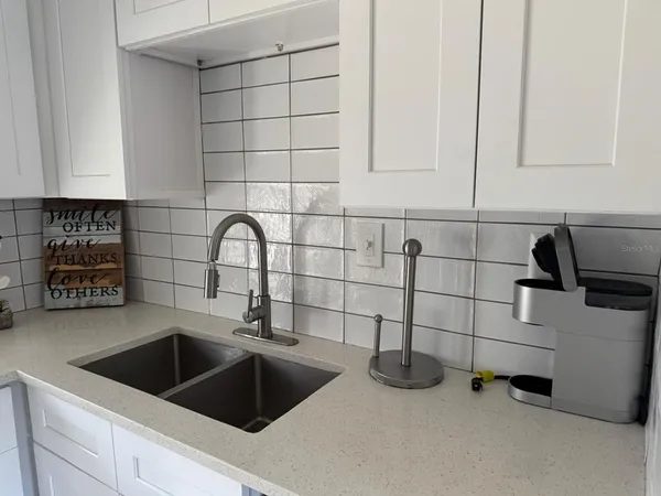 a kitchen with a sink and cabinets