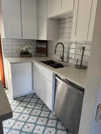 a kitchen with a sink stove and cabinets