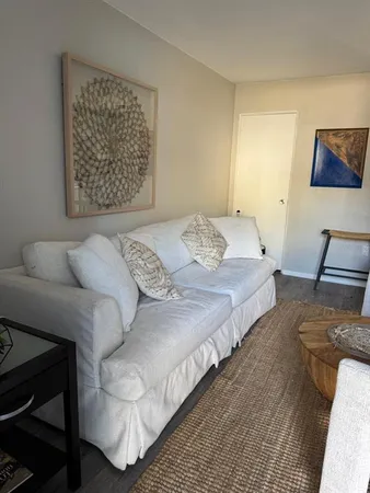 a bedroom with bed couch and window